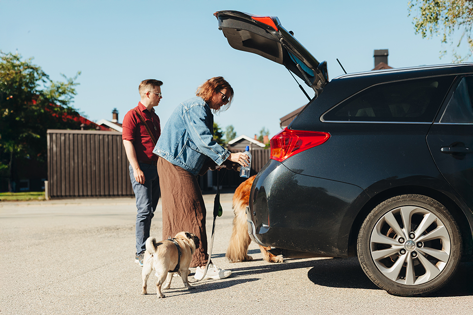 A family loading up their car for going on a trip.