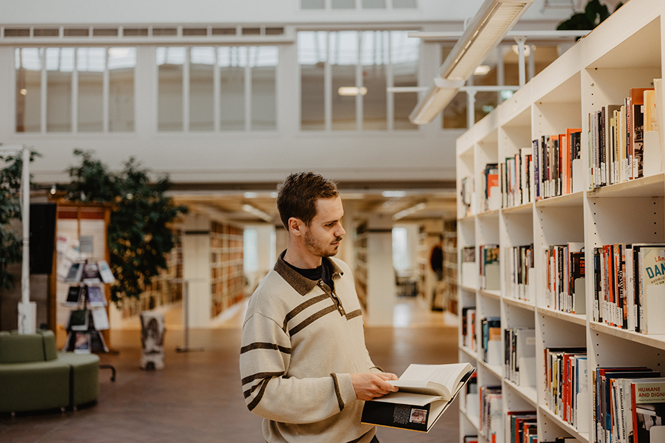 A young man in a university library