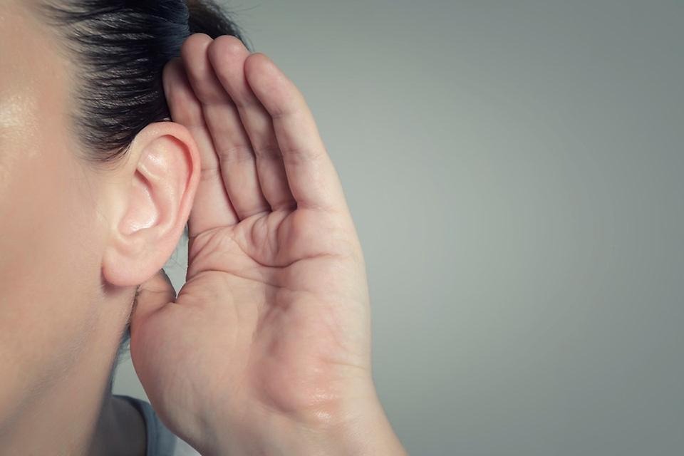 Öra med en hand kupad bakom örat som för att höra bättre