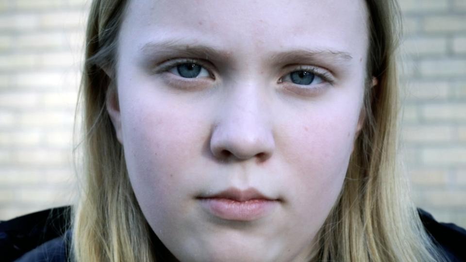 Närbild på flicka med blont hår, som ser ut att vara i mellanstadieålder.