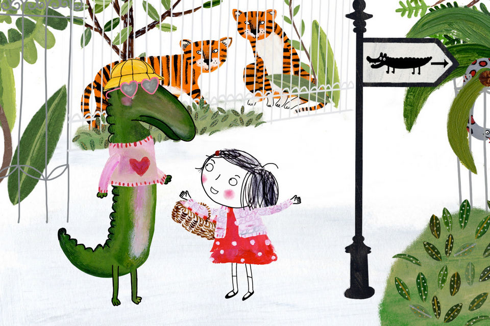 En flicka pratar med en krokodil.