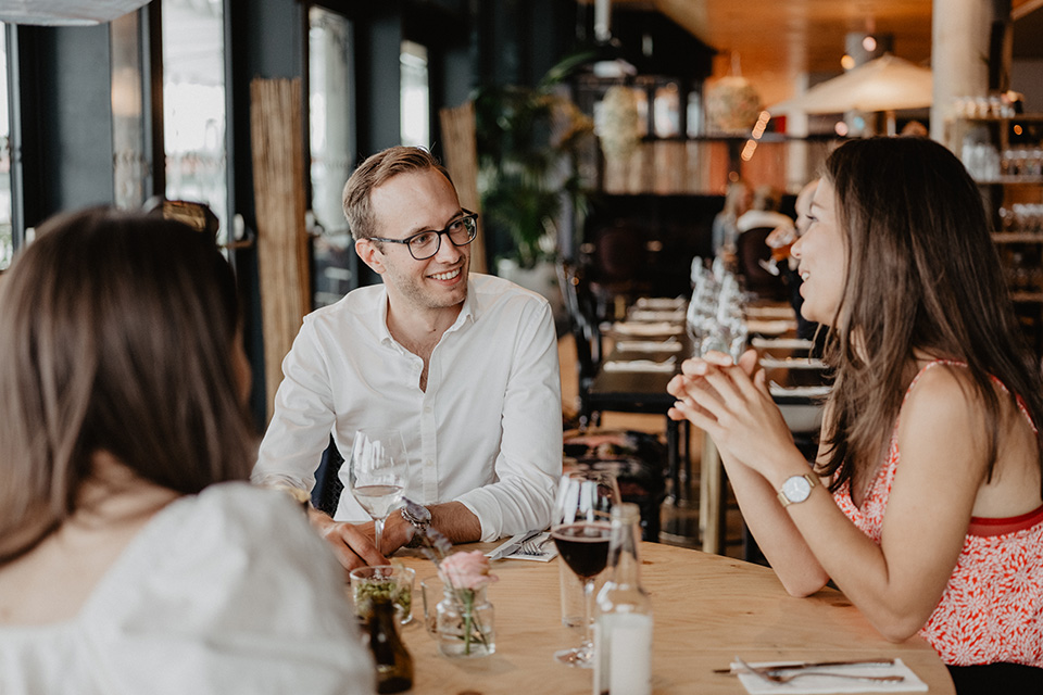 Image of people talking at a restaurant.