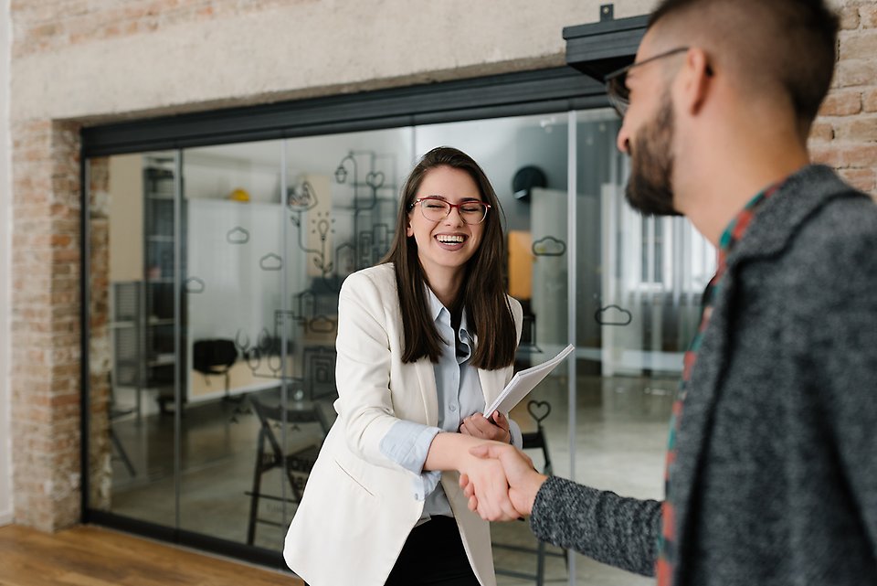 Woman shaking a hand om a employer