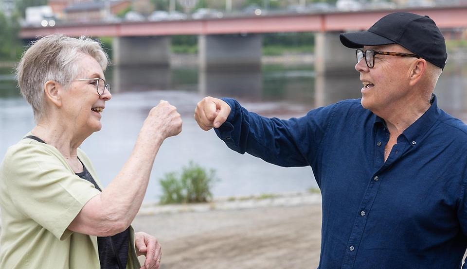 Glad man och kvinna som boxar nävarna mot varandra